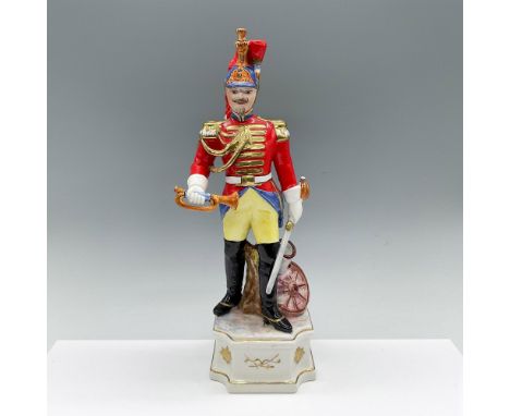 Hand modeled and hand painted figure of a soldier in dress uniform. He is shown holding a sword and bugle horn, and standing 