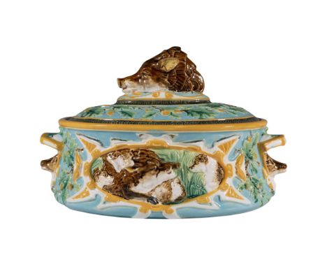 An oval covered serving dish with stag heads as the double handles, and a boar head as the finial. Panels of hounds hunting b