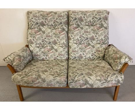 An Ercol light wood framed 2 seater sofa with floral and hummingbird design upholstered cushions. Slat backed wooden frame. A