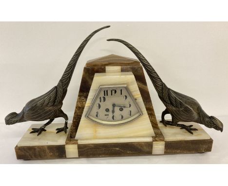 A large Art Deco marble mantle clock flanked by a pair of cold painted spelter peasants. Pendulum clock in working order, com