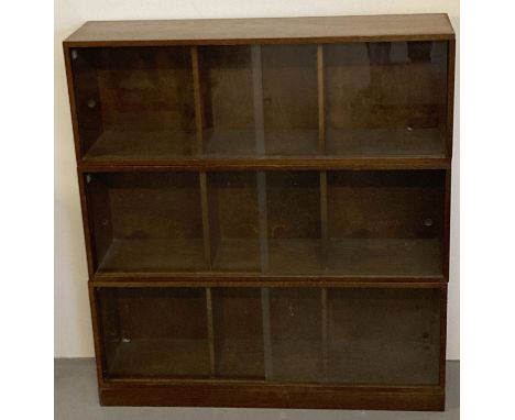 A vintage 1940's solid dark oak 3 sectional 'Unix' stacking system; 3 units with 3 bays. Complete with wooden base plate and 