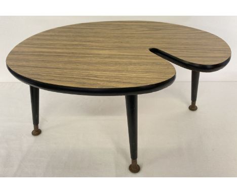 A small vintage 1960's Formica topped coffee table with screw in tapered legs. Oval shaped table with medium oak effect Formi