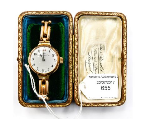A 9ct gold mid size wristwatch on gold strap, Thomas Russell Liverpool, white enamel dial n original box