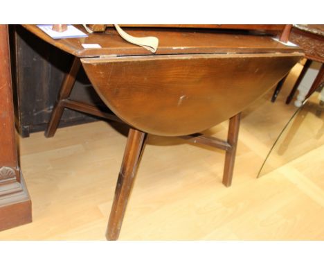  An Ercol elm topped drop-leaf dining table, with an ash frame