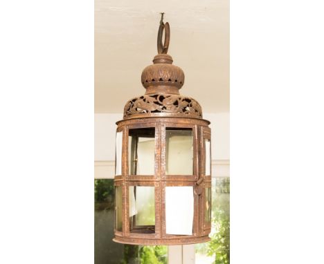 An iron lantern, fretted and chased top, above double panelled and chased body 