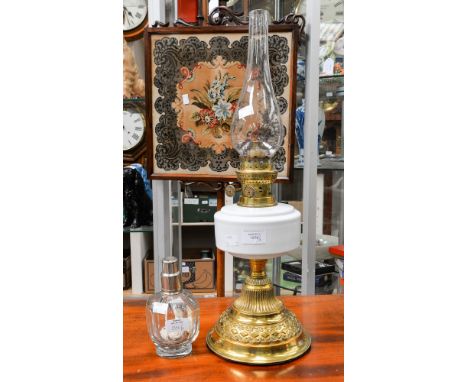 A Martins Patent brass twin burner oil lamp, having embossed brass base, milk glass reservoir (cracked) and chimney, with a F