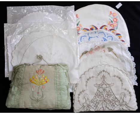 A collection of vintage tea cosy's to include a linen embroidered with pink flowers and two line applicaed - a white embroide