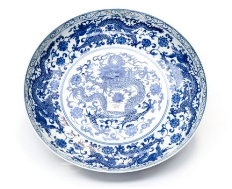  A Chinese blue and white circular charger, Qianlong mark, decorated with a central five claw dragon within a lotus scroll an