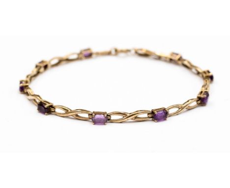A 9ct gold and amethyst bracelet with alternate gold cross links and claw set oval amethysts the bracelet measuring approx 7.