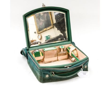 A 1920's Art Deco vanity case wih fitted interior, mirrored lid, four bottles with yellow & green enamel finish plus brush an