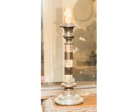 A Serpentine hardstone candlestick, alternating black and white bands, octagonal section