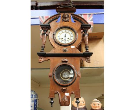 A mahogany and ebonised wall clock, having 8 day with Roman numerals and cased pendulum 