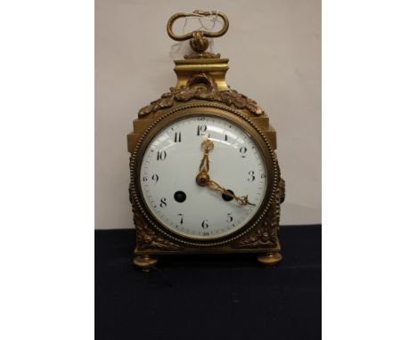 A brass French mantle clock, having enamelled dial with Arabic numerals acorn and oak leaves decoration with serpent handle t