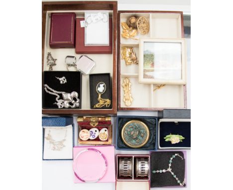 A collection of costume jewellery comprising of six yellow metal brooches, an enamel bangle, ceramic brooches, white metal ne