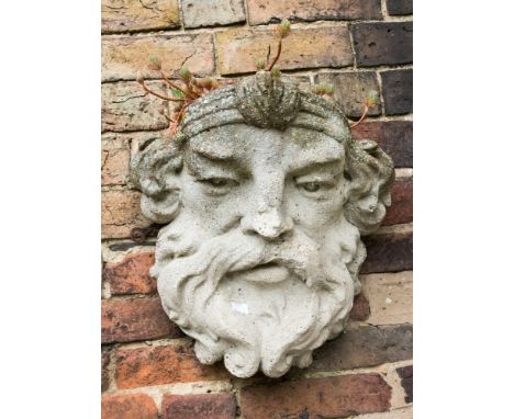 A stone Bacchanalian head planter, bearded man with headdress