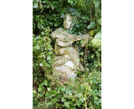 A stone figure of a putto playing a lute, sitting on a sphere 