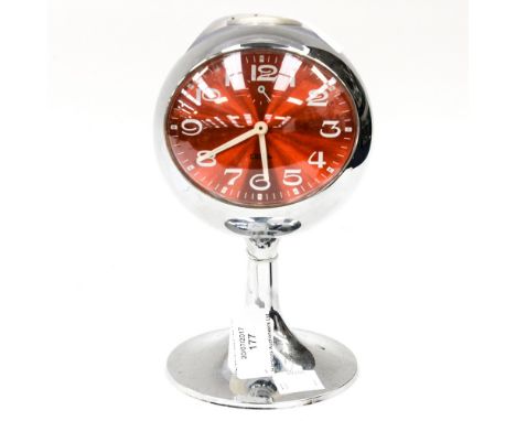 A Coral West German retro style alarm clock, late 20th Century, in the 1960s style, the globular clock case raised on a pedes