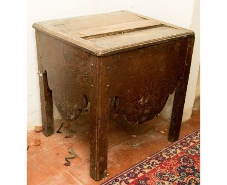 A George III oak commode, square section with fretted apron