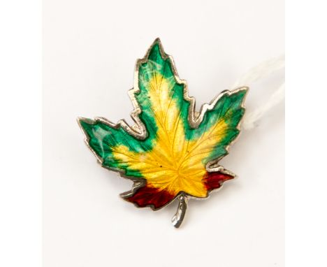 A silver and enamelled leaf brooch, circa 1940s, in the form of a Maple Leaf in green, yellow and red basse taille enamel, Bi