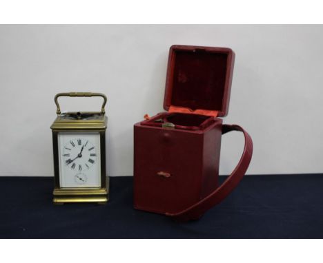 A 19th French repeating alarm carriage clock, brass corniche case with visible escapement, white enamel Roman dial with subsi