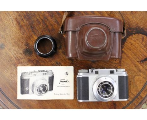 A mid 20th century Franka 24 x 36 miniature camera, fitted in a leather casing, complete with instructions