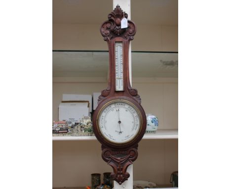 A late 19th Century/Edwardian solid carved mahogany barometer Dolland of London, enamel dial 