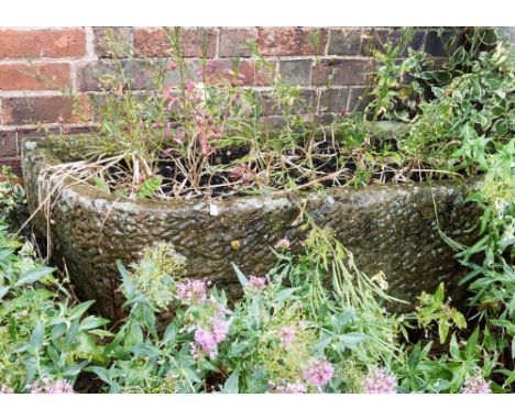 A large sandstone trough planter