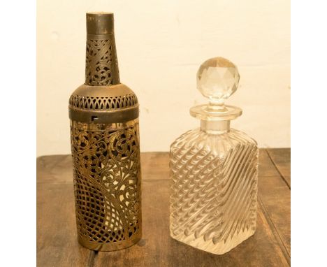 A Victorian glass decanter and fretted metal bottle cage 