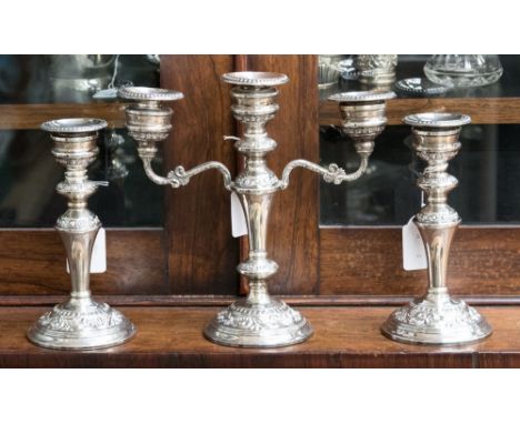 Filled solid silver candlestick garniture, comprising two single candlesticks and a three arm candle holder, hallmarked to ba