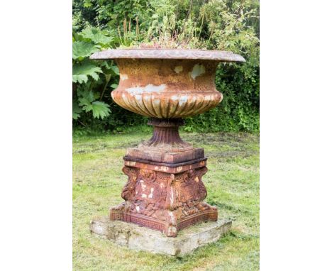 A cast iron Campana urn planter and plinth 