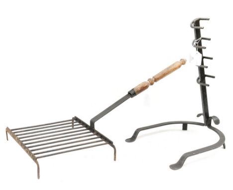 An 'antique' wrought iron standing fire grill, fitted with a turned wooden handle, together with a further wrought iron fires