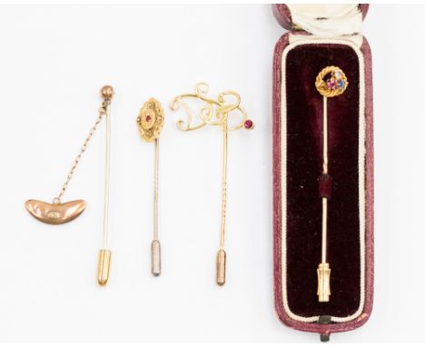  A collection of four stick pins comprising of Edwardian stick pin star set with ruby and floral detail, a know tie pin with 