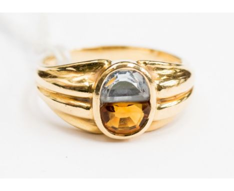  An 18ct stamped gold ring, with an oval rubover setting, set with both aqua and citrine, size Q, with a total gross weight o