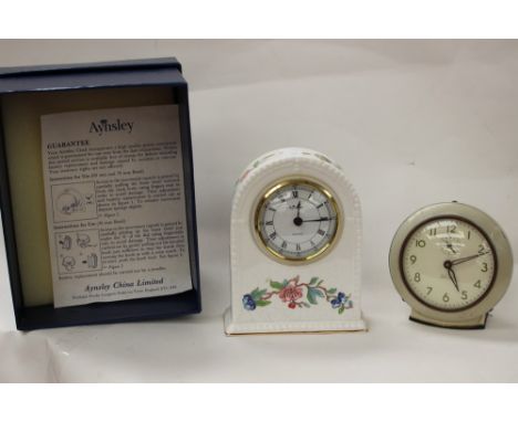 An Aynsley China "Pembroke" mantel clock, the white ground decorated with flowers, in presentation box together with a West C