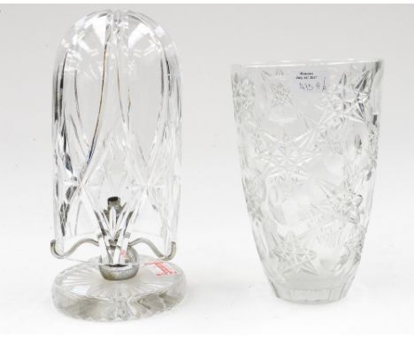 A 1930 glass lamp base with cut glass globe; together with a stars and moon pattern cut glass vase (2)Please note: this item 