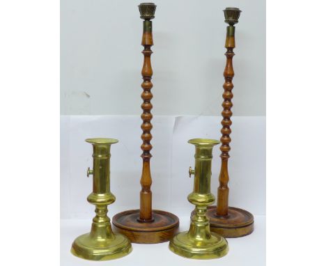 A pair of 19th Century brass candlesticks and a pair of tall bobbin turned candlesticks 