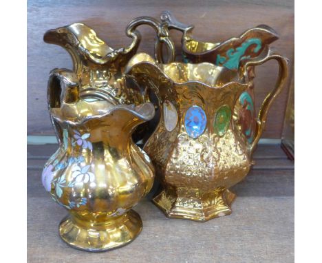 Four 19th Century lustre jugs including one with clock dial 
