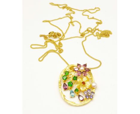 A silver gilt, carved pearl, Russian diopside, amethyst and tanzanite pendant 