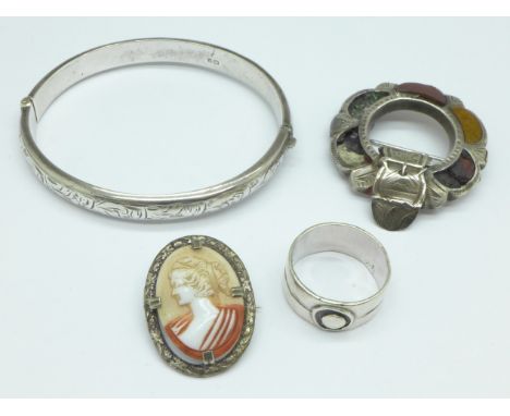 A silver ring, a silver bangle, a cameo brooch and Scottish brooch lacking stones 
