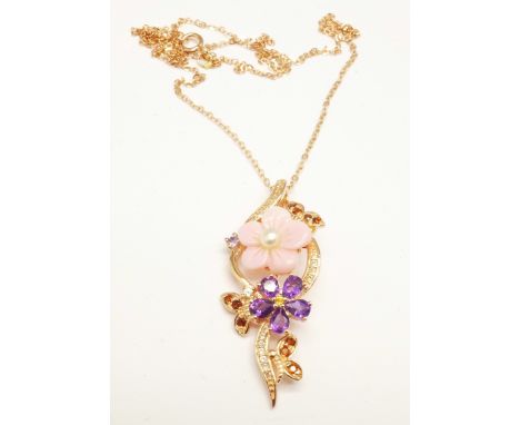A silver gilt, carved pink pearl, Russian diopside, amethyst and tanzanite pendant 