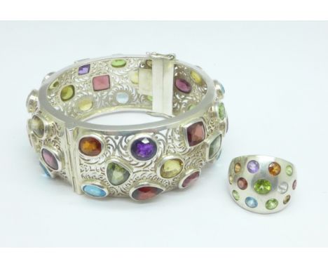 A white metal bangle and similar 925 silver ring, M, set with topaz, amethyst, aquamarine, garnet and citrine