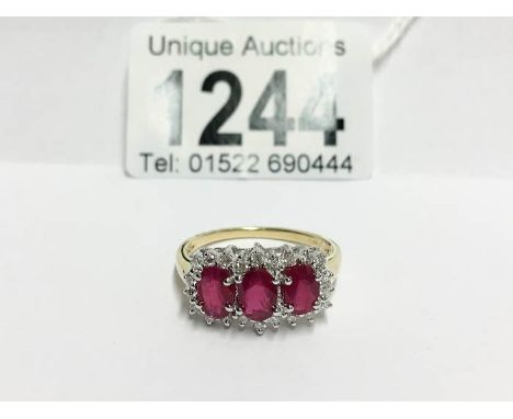 An 18ct yellow gold ring set ruby and diamonds, size T