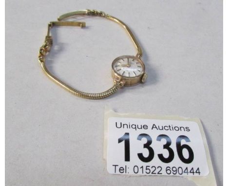 A 9ct gold ladies Rotary 21 jewel wrist watch on 18ct gold bracelet