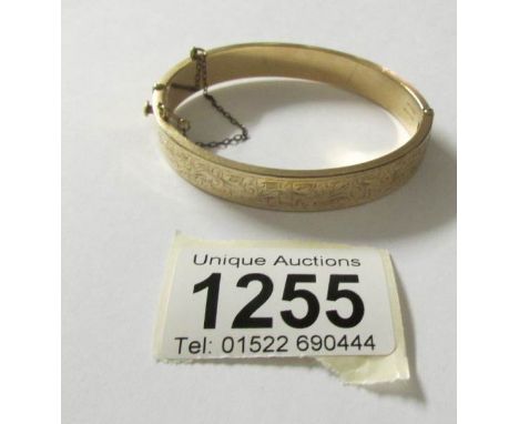 A bangle marked 9ct gold metal core