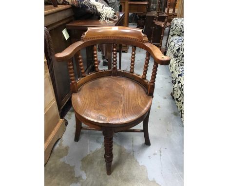 Late Victorian elm Captains chair with solid seat, bobbin turned supports joined by stretchers