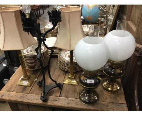 Two pairs of brass oil lamp style table lamps, two pairs of brass candlesticks table lamps and a gothic wrought metal lamp