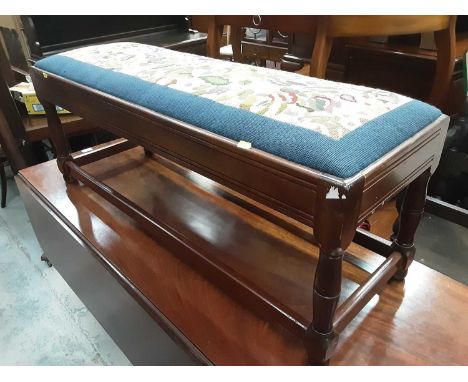 Long footstool with tapestry top on turned and block legs joined by stretchers, 105.5cm wide, 36cm deep, 42cm high, and a bra