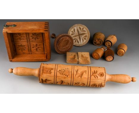 A collection of American Folk Art hand carved wood press moulds including birds, flowers, large Acorn mainly for butter and r