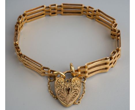 A gate bracelet. The plain polished gate bracelet with padlock clasp, aporox length of bracelet 185mm, padlock hallmarked 9ct