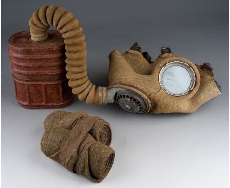 WW2 British Army Respirator. Cloth covered facepeice type dated 1944. Plus a pair of post war Puttees.